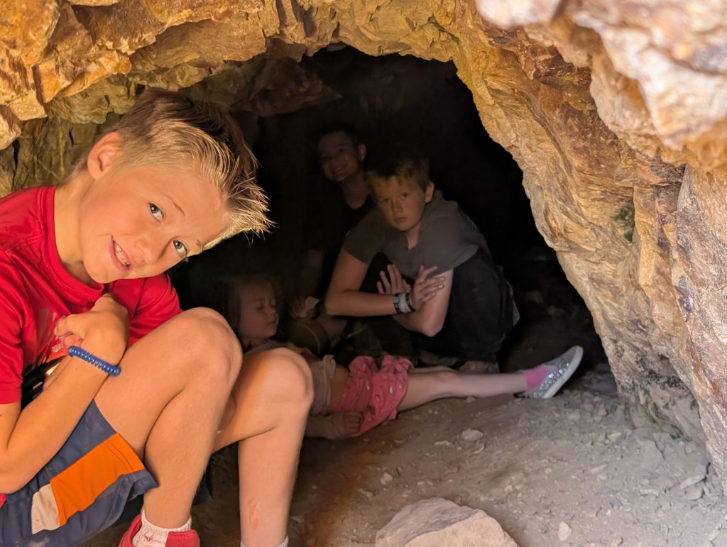 My kids inside a cave next to the trail