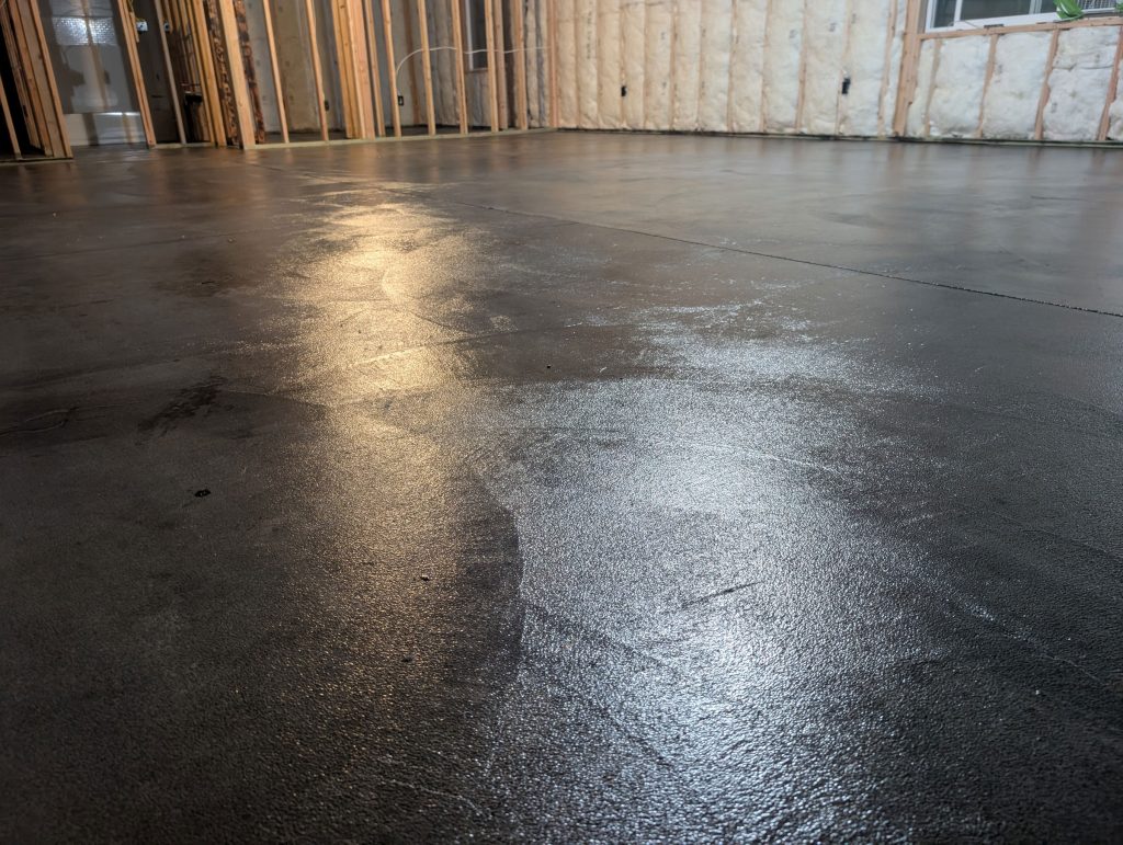 Concrete floor after final wet look sealer layer is applied