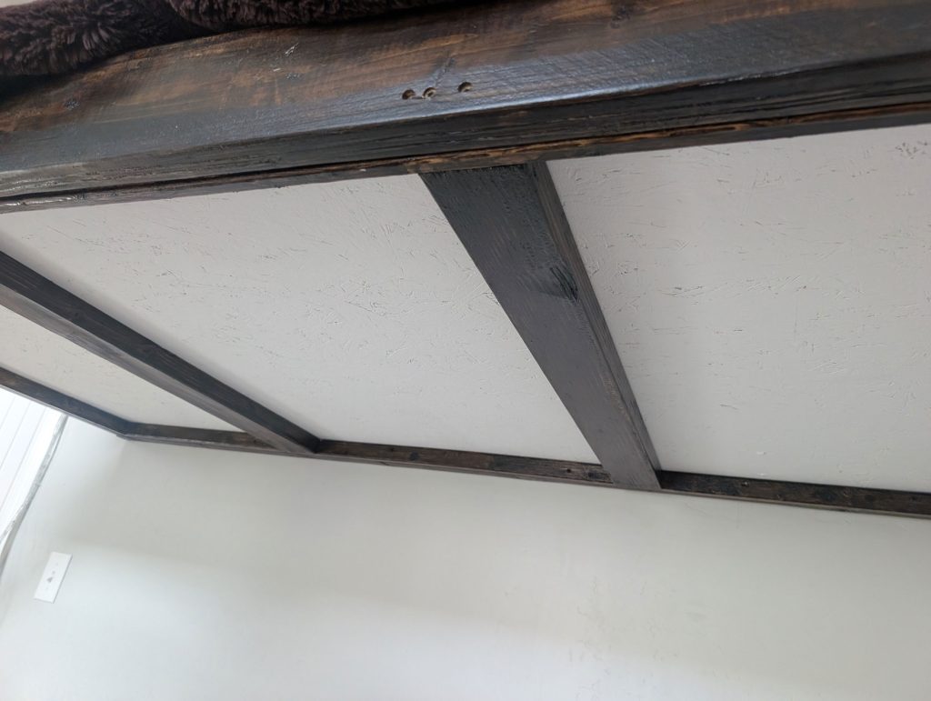 Painted white plywood on the bed frame