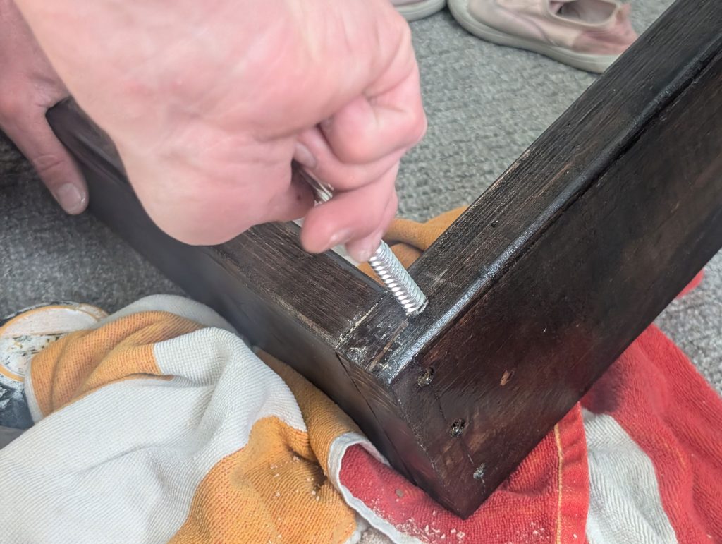 Placing screw eye hook into the bed frame