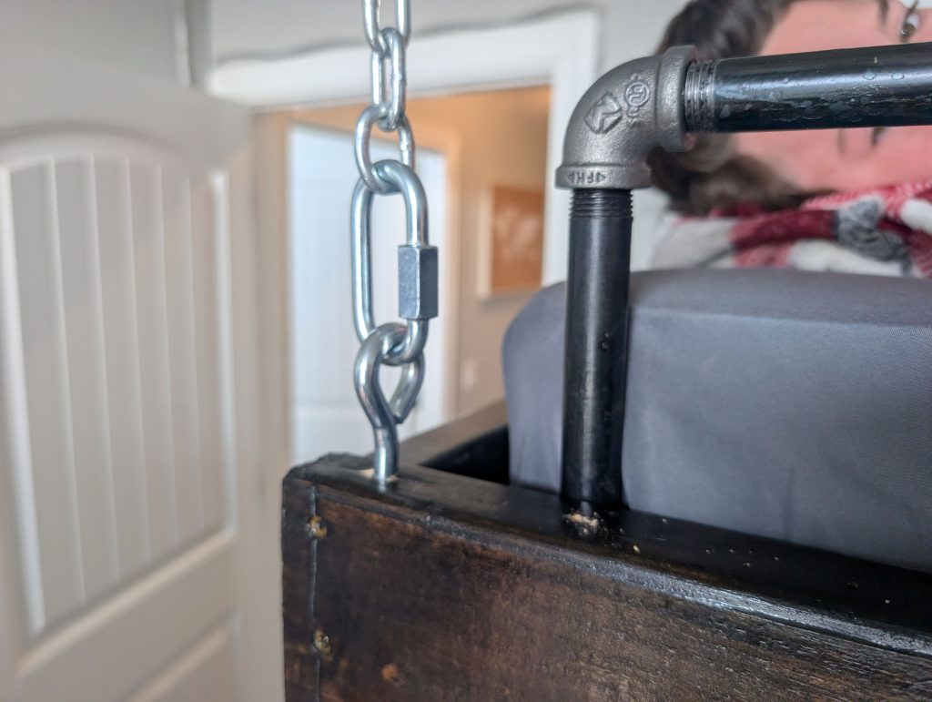 The chain connected to the bed frame