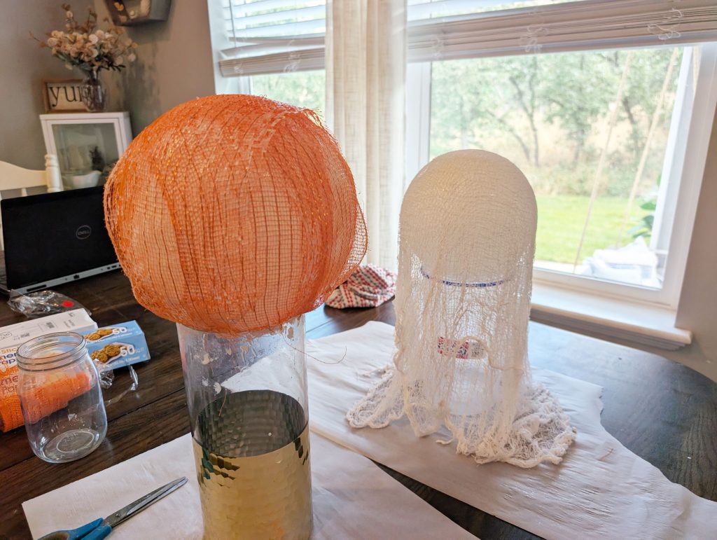 Drape the creepy cloth over the balloons