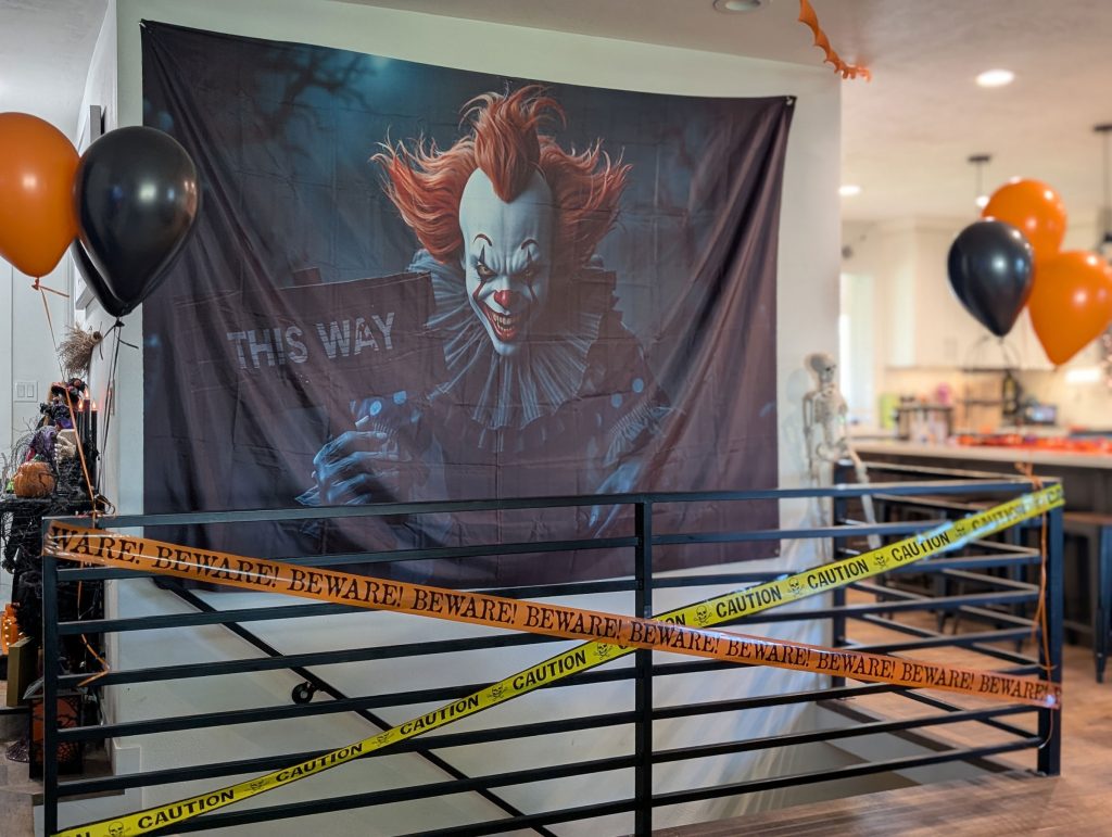 Decorate with a big Halloween poster and balloons